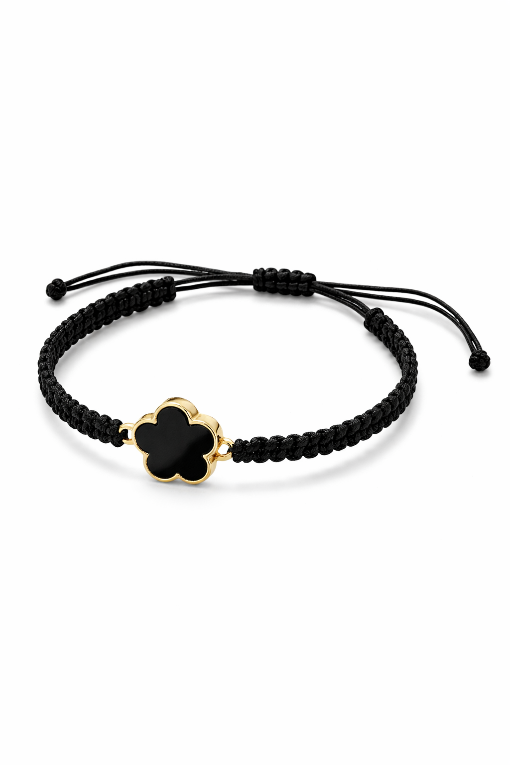 Black braided bracelet with a gold clover-shaped charm on a white background