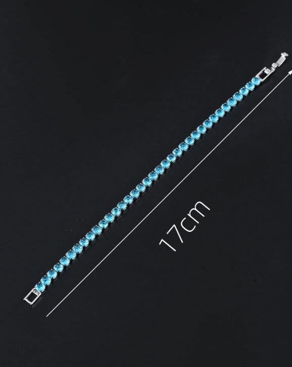 Blue beaded bracelet with silver clasp on a black background