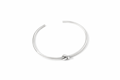 Silver bracelet with a knot design on a white background