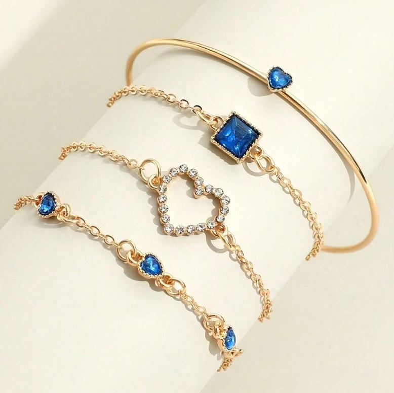 Gold bracelet with blue gemstones on a light background