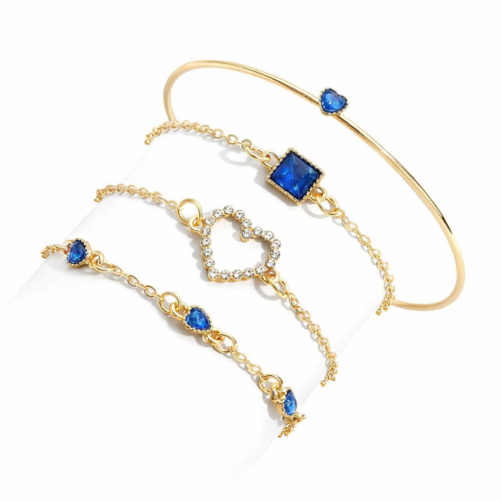 Gold bracelet with blue gemstones on a white background