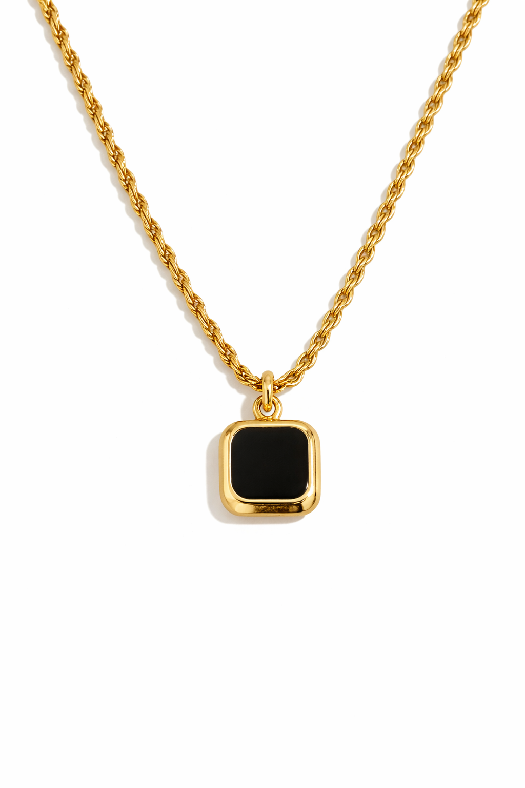 Gold necklace with a black square pendant on a white background