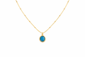 Gold necklace with a blue pendant on a white background