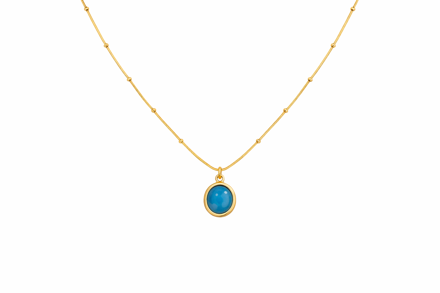 Gold necklace with a blue pendant on a white background