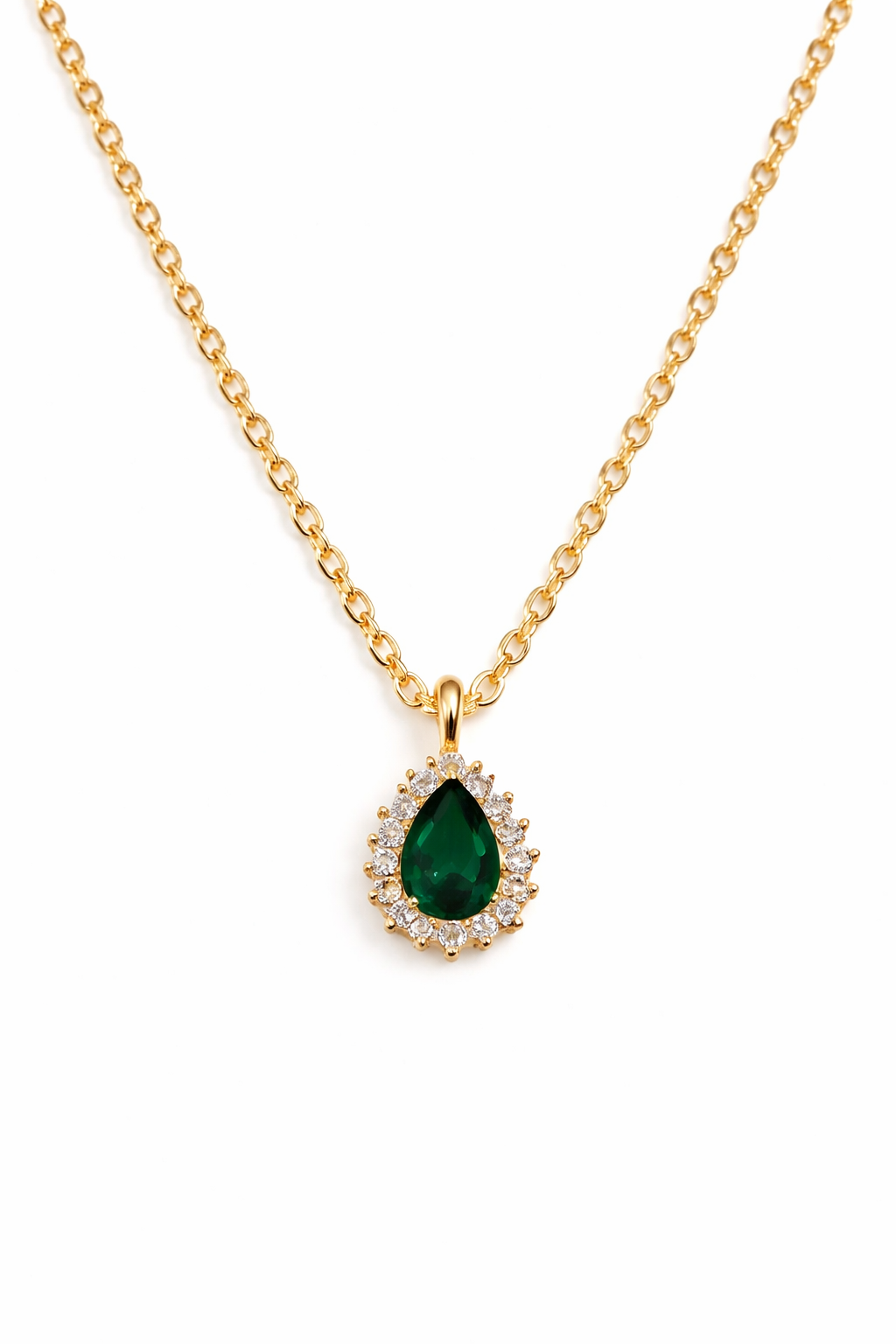 Gold necklace with a green teardrop pendant on a white background