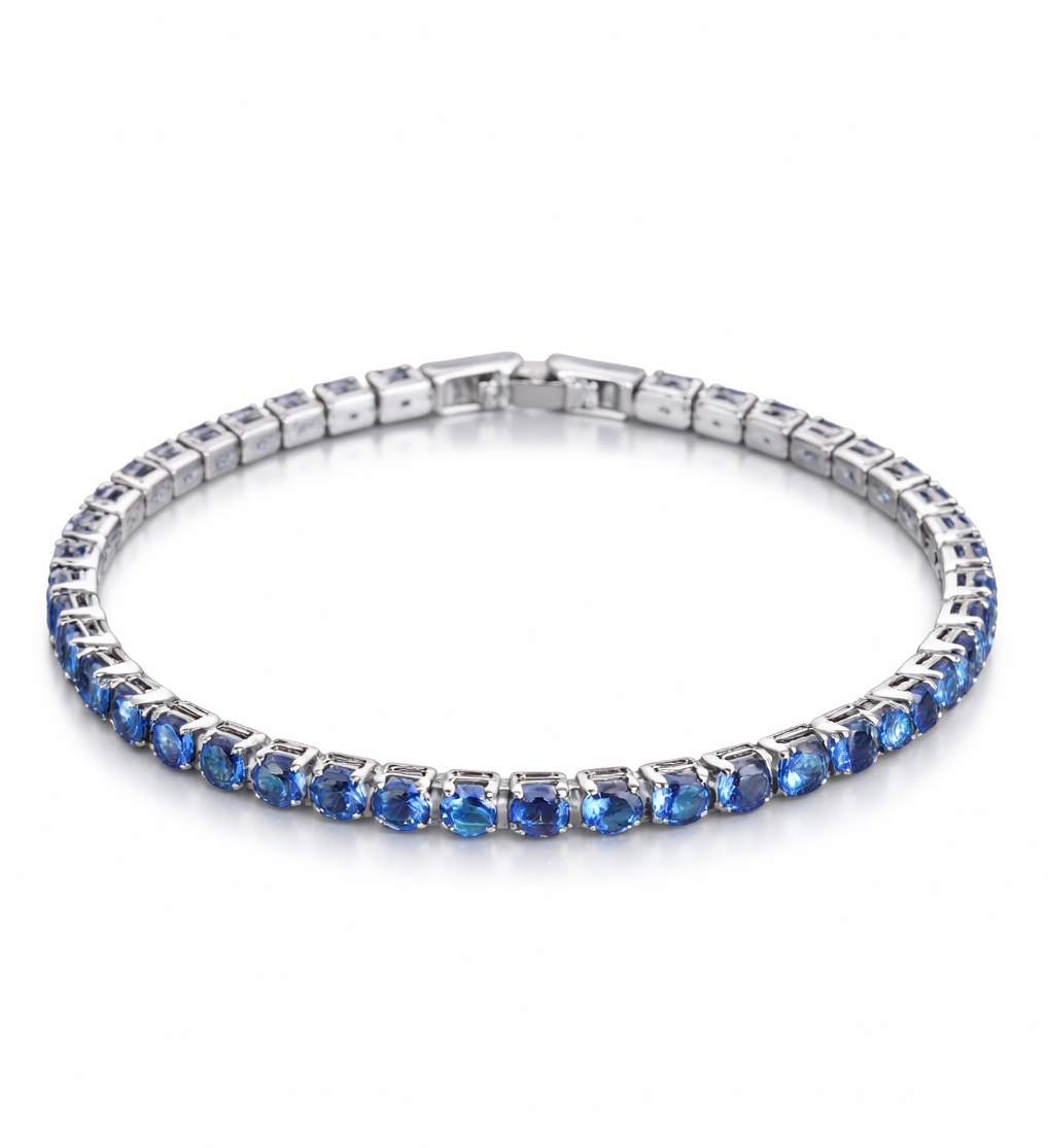 Silver bracelet with blue gemstones on a white background