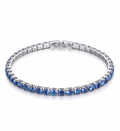 Silver bracelet with blue gemstones on a white background