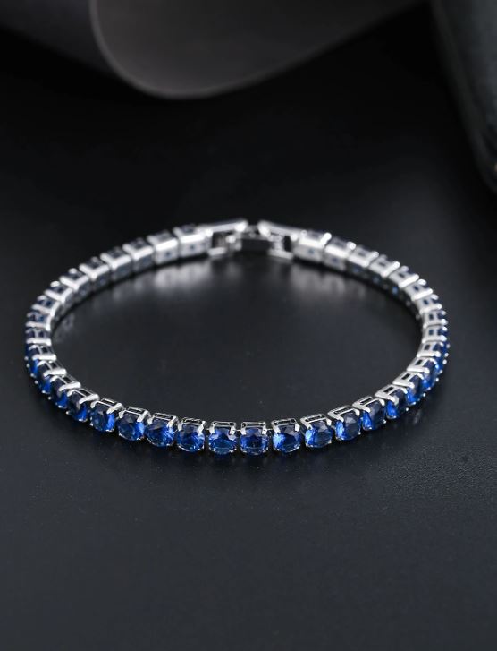 Silver bracelet with blue stones on a dark background
