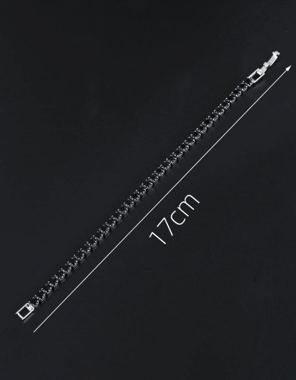 Silver bracelet with measurement label on a black background