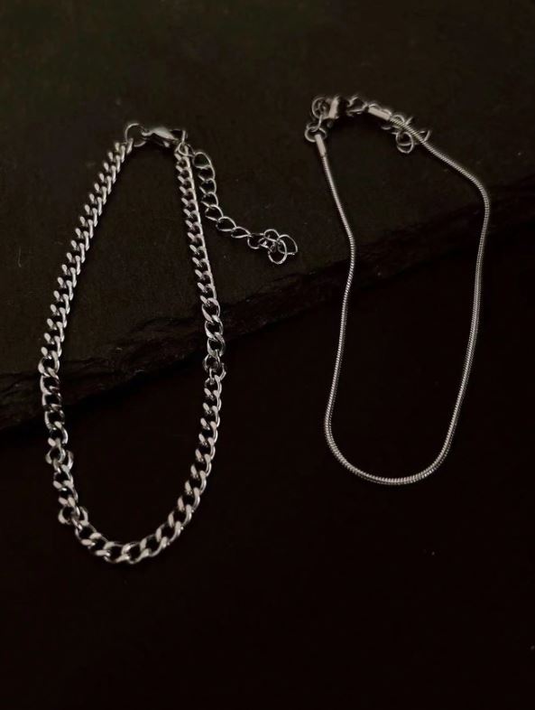 Silver chain necklace on a dark surface