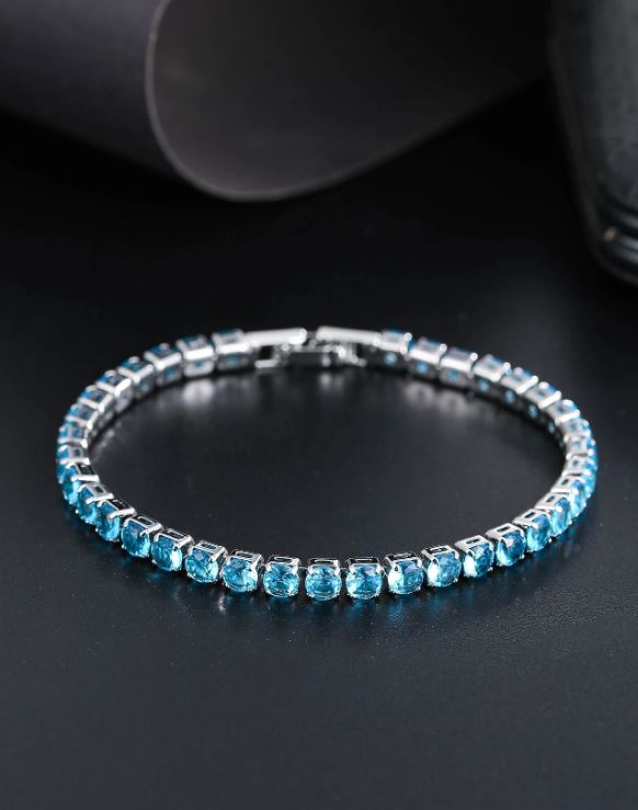 Silver bracelet with blue gemstones on a dark background